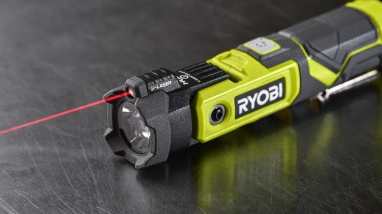 Ryobi-brand flashlight pointing a red laser