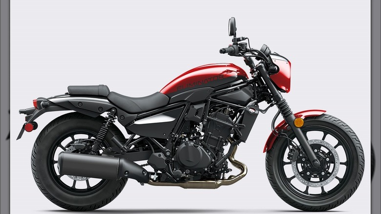 A Kawasaki Eliminator ABS cruiser motorcycle in a bright red and black color, photographed from the side against a plain light backdrop.