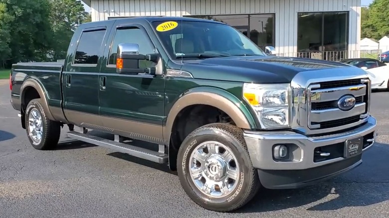Green Gem Metallic Ford Super Duty parked in a lot