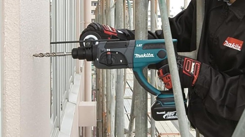 Person using Makita hammer drill