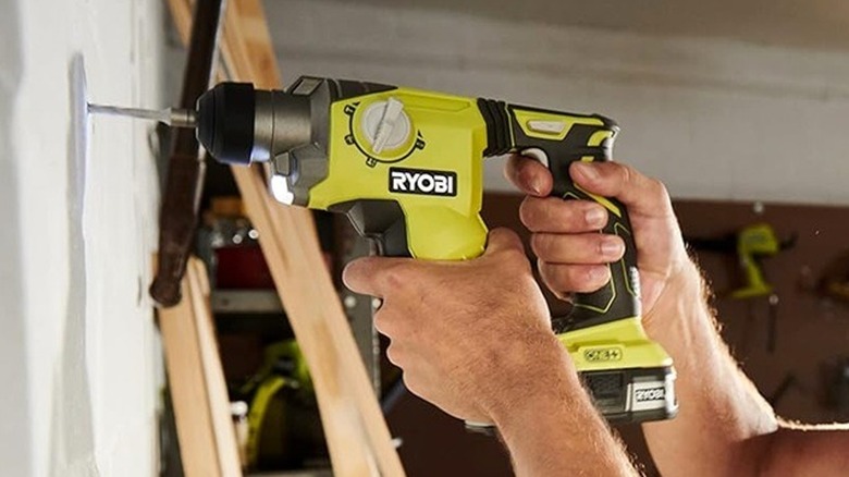Person using Ryobi hammer drill