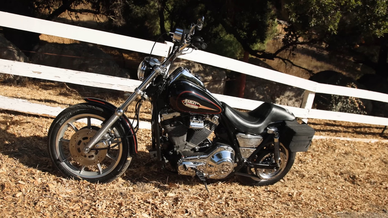 A black classic Harley FXRS Convertible from 1993 at the side of a road