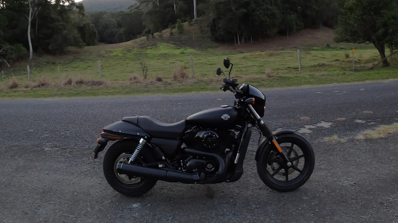 A black Harley Street 500 parked at a quiet intersection