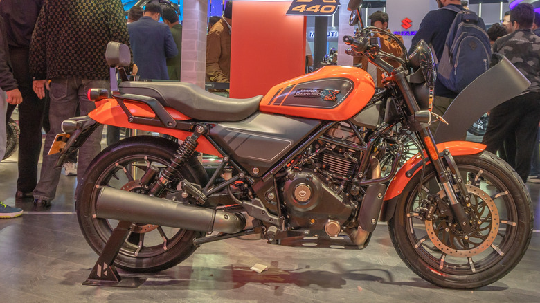 An orange and black Harley X440 on display to consumers at a trade show