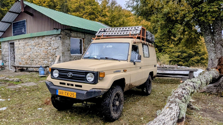 Toyota Land Cruiser 70 Series with a roof tent attached front 3/4 view