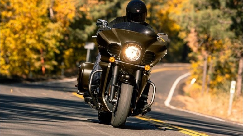 A man riding brown Kawasaki Vulcan Vaquero motorcycle