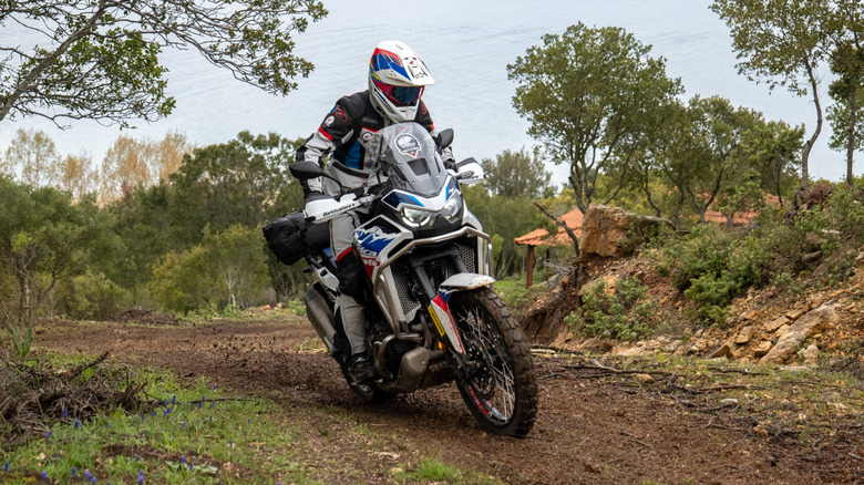Honda Africa Twin climbing on muddy terrain
