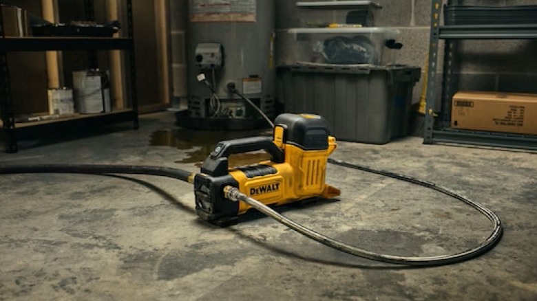 Transfer pump on a basement floor draining a water heater