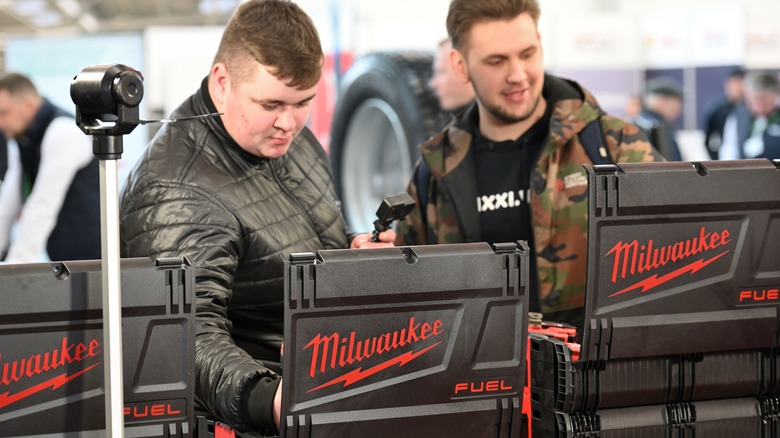 Two people using Milwaukee tools