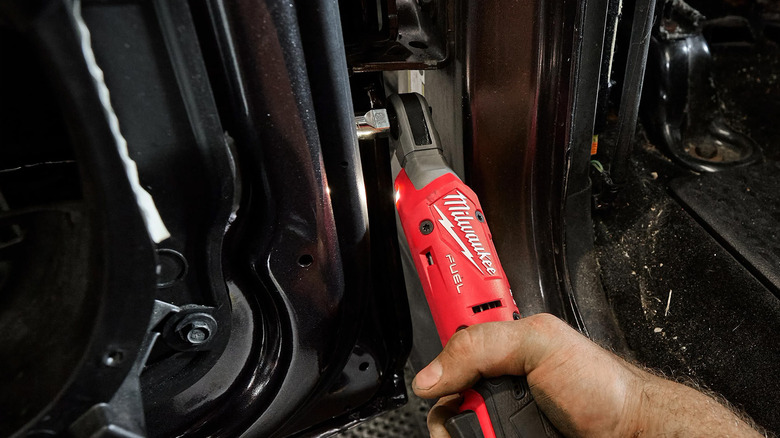 A Milwaukee brand ratchet tightening a bolt