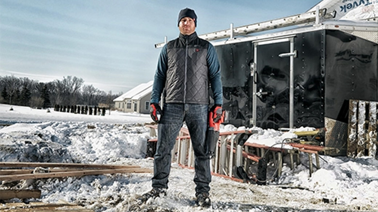 A man wearing a heated vest on a jobsite in the winter
