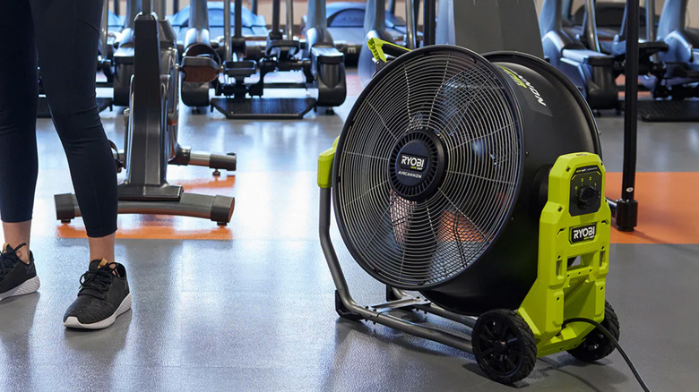 A Ryobi floor fan set in a gym.