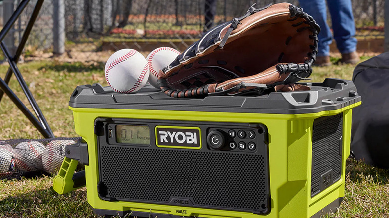 A Ryobi Bluetooth speaker with two baseballs and a glove.