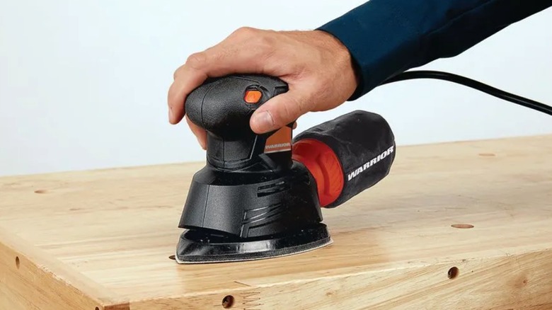 Using a palm sander on wood