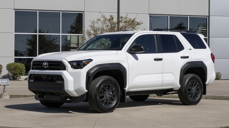 A white Toyota 4Runner parked in the lot behind an industrial building