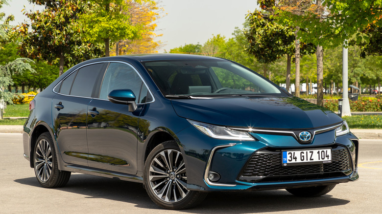 A current-gen Toyota Corolla finished in blue parked outside in autumn