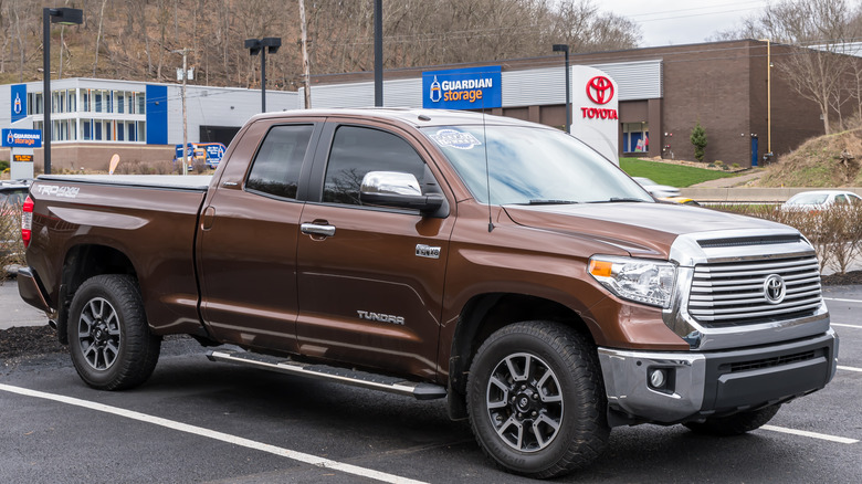 A used Toyota Tundra pickup in brown for sale at a dealership parked outside on a fall day