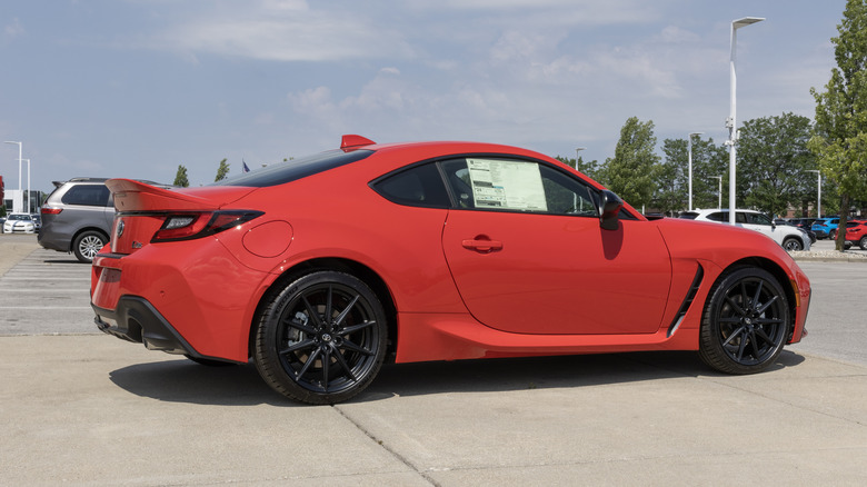 A red Toyota GR86 standing in a parking lot on a warm summers day