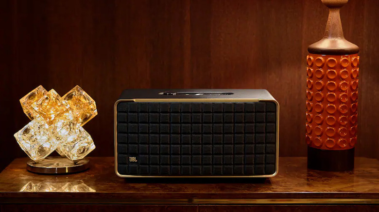 A JBL Authentics 500 speaker on a table with a lamp