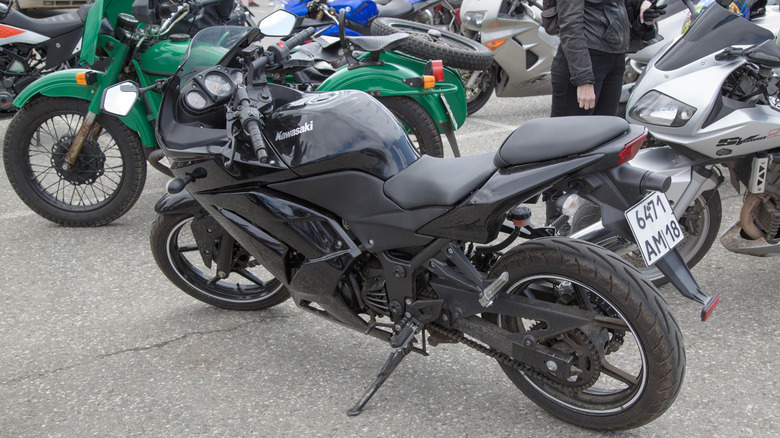 Black sportbike Kawasaki Ninja 300 parked.
