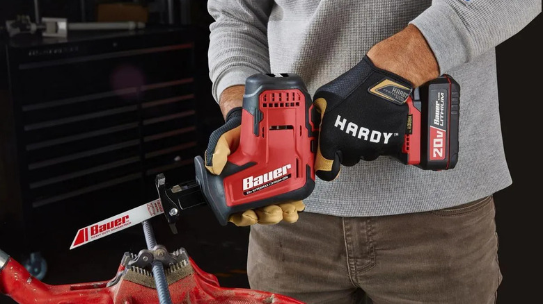 Worker using Bauer reciprocating saw