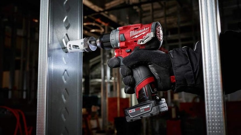 Man using tool from Milwaukee 2598-22 M12 Fuel 2-Piece Kit