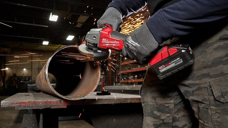 Grinding a metal pipe with the Milwaukee 2880-20 M18 Fuel Cordless Angle Grinder