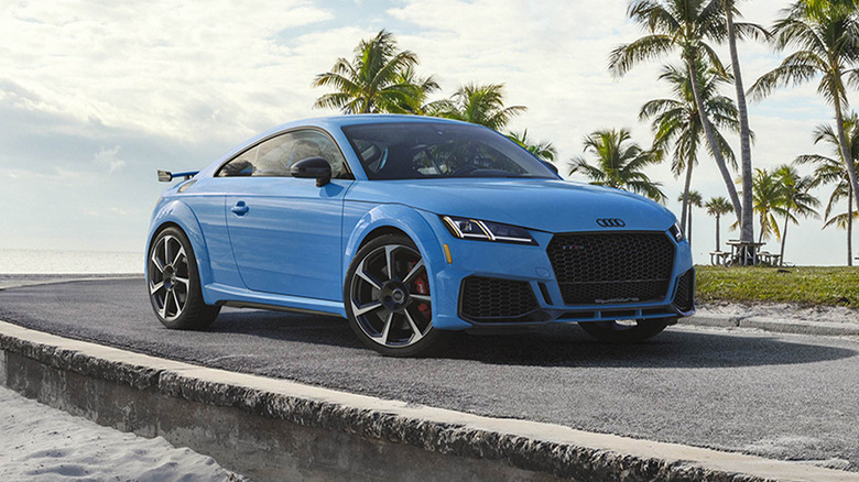 A blue 2020 Audi TT-RS parked by the beach