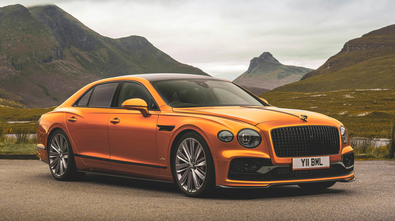 Orange Bentley Flying Spur Speed parked in the mountains