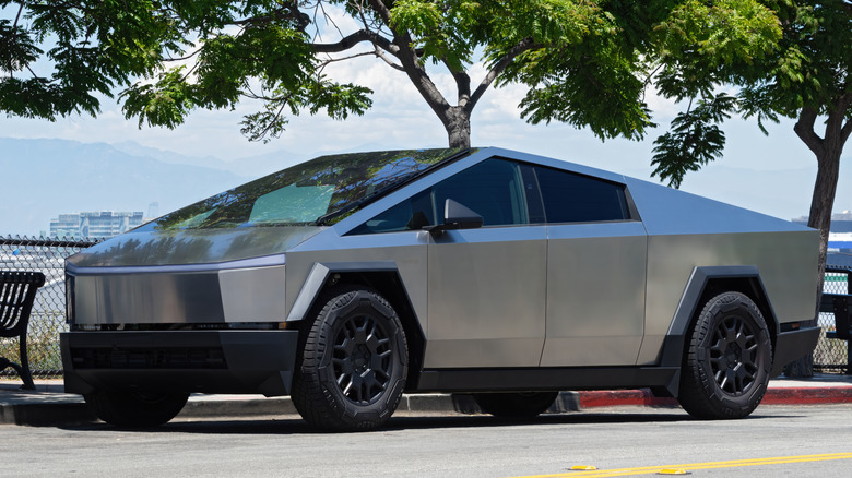 tesla cybertruck parked on a street