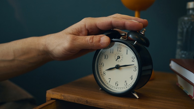 Hand on a bedside clock