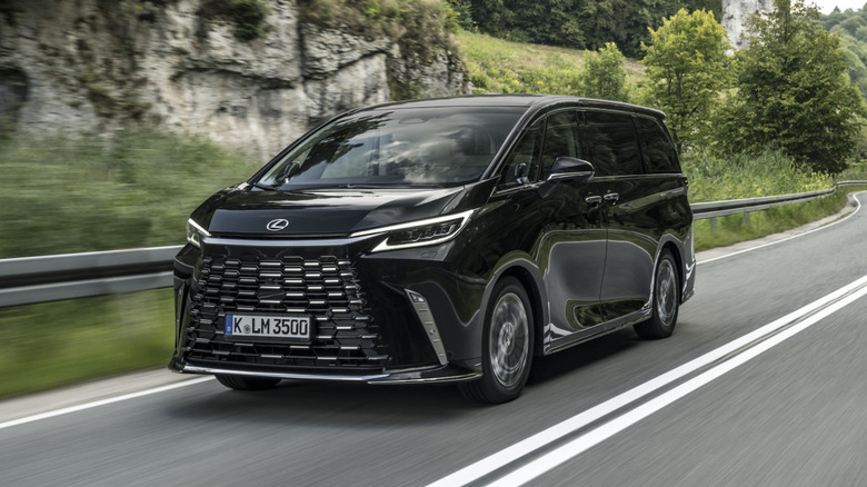 Lexus LM driving down a road