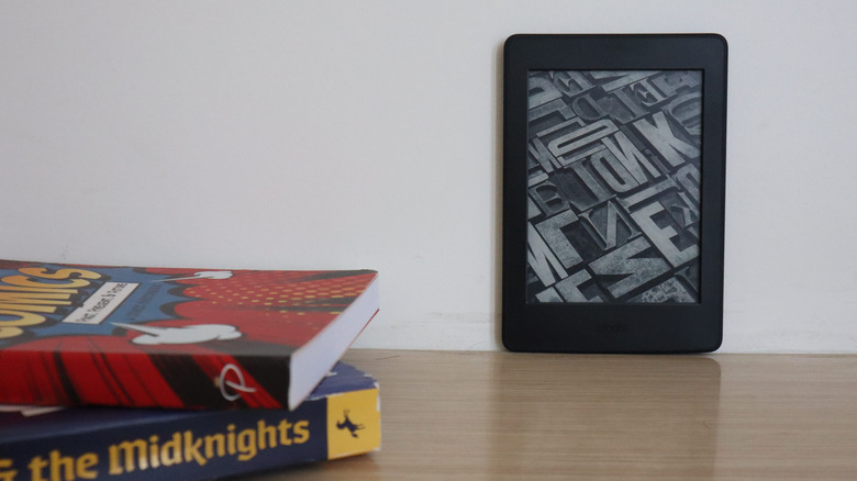 Kindle next to Book stack