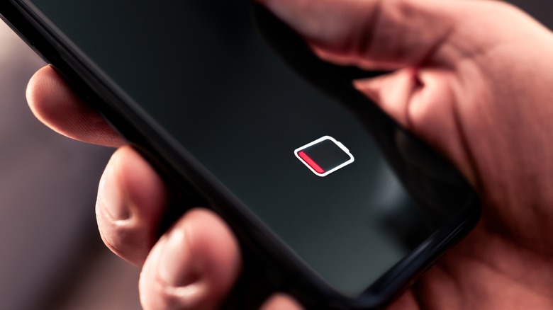 Low battery symbol on smartphone screen