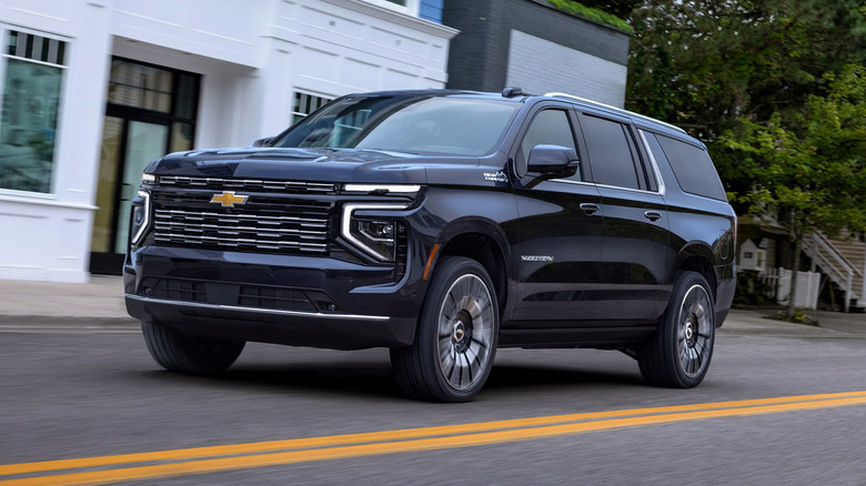 A dark blue 2025 Chevrolet Suburban driving