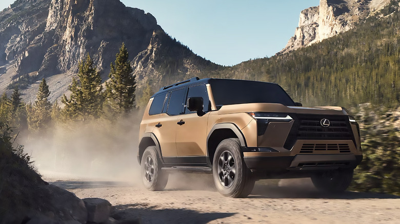 A bronze 2025 Lexus GX 550 Overtrail driving