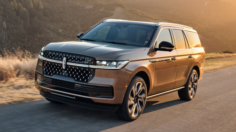 A bronze 2025 Lincoln Navigator driving