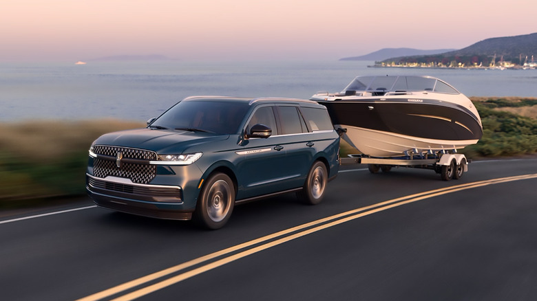A blue 2025 Lincoln Navigator towing a boat