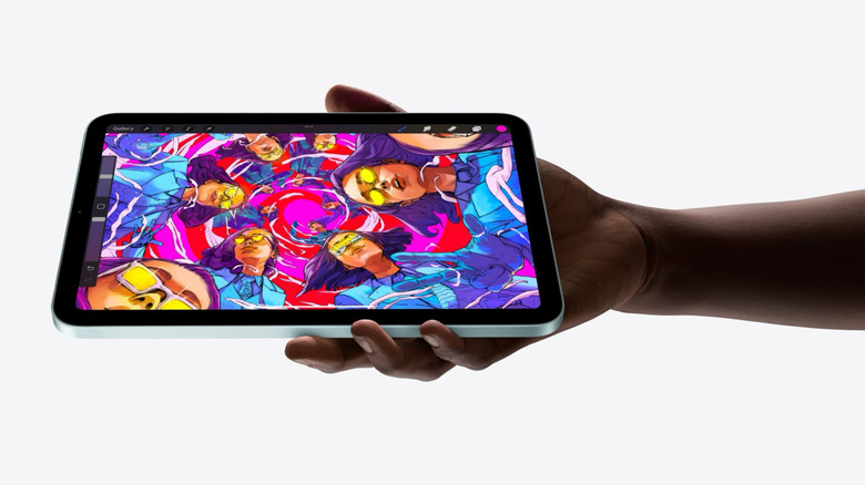 An Apple iPad showing a woman in different poses within a swirl while being held in someone's hand.