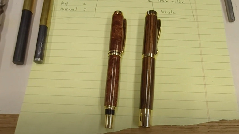 Wooden pens on a yellow piece of paper
