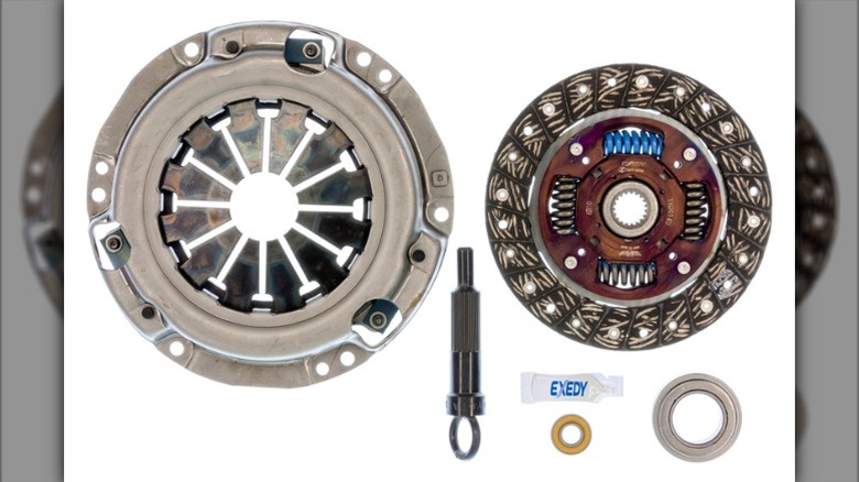 An Exedy OEM clutch kit, with all its parts laid out on a white background.