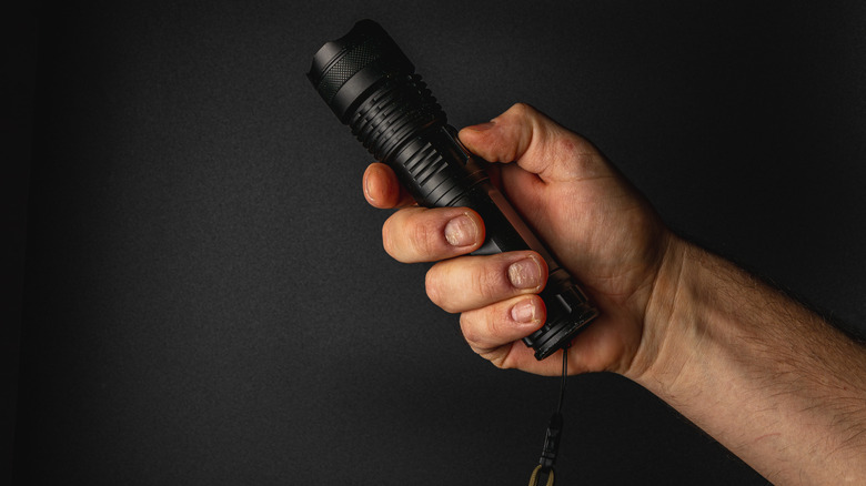 A man holding a flashlight.