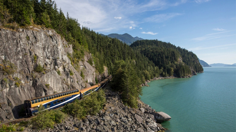 A Rocky Mountaineer train riding along a coastline