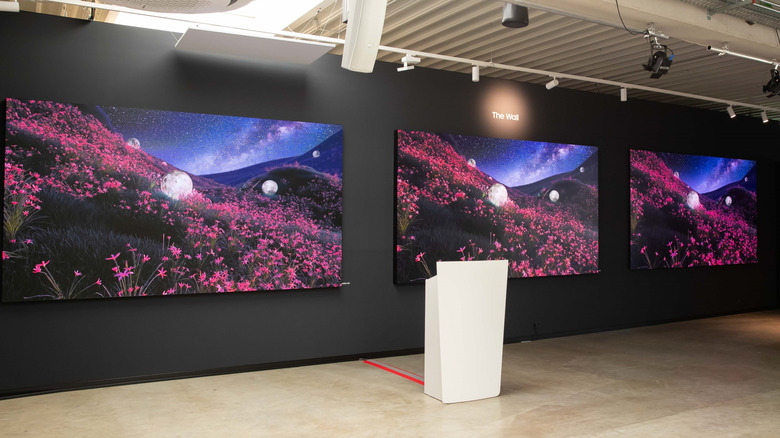 Samsung TVs and displays showcased on a wall.