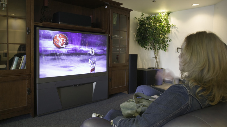 People watching a rear projection TV.