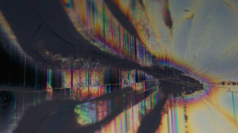 Closeup of a TV with dead and messed up pixels.