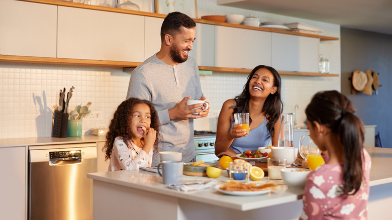 A family enjoying breakfast in the kitchen.
