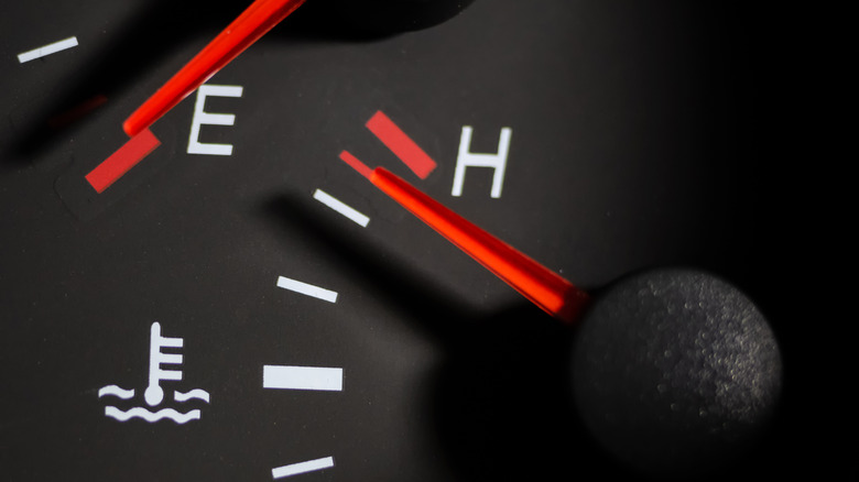 A car's temperature gauge all the way up to H, showing the car's overheating.