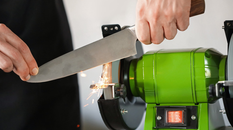sharpening a knife with bench grinder