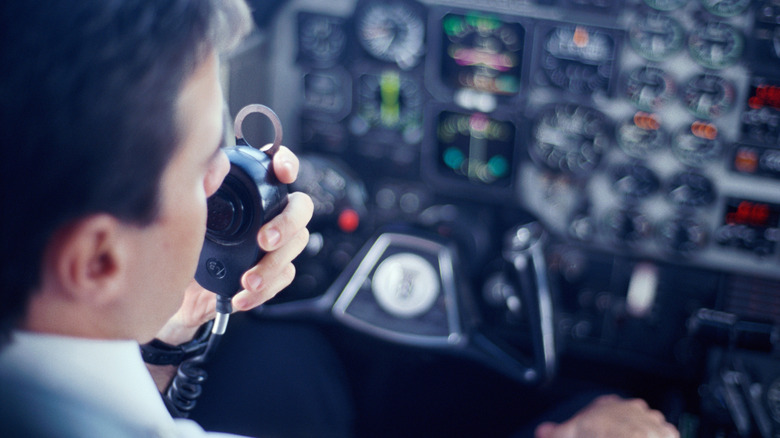 Pilot speaking into radio